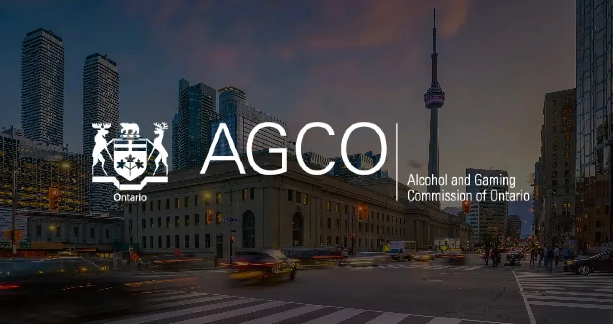 The AGCO (Alcohol and Gaming Commission of Ontario) logo is displayed over a cityscape of Toronto at dusk, with cars moving through a busy intersection and the CN Tower visible in the background.