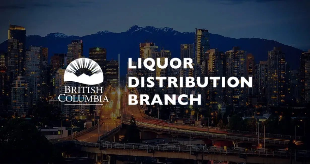City skyline at dusk with mountains in the background. The British Columbia Liquor Distribution Branch logo and text are prominently displayed over the image.