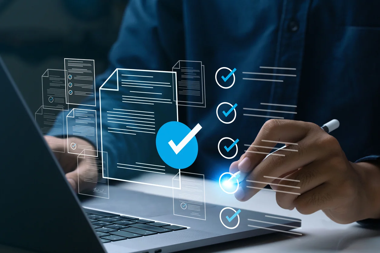 A person works on a laptop, interacting with virtual checklists and documents. Blue checkmarks and digital icons illustrate task completion, representing productivity and digital organization.